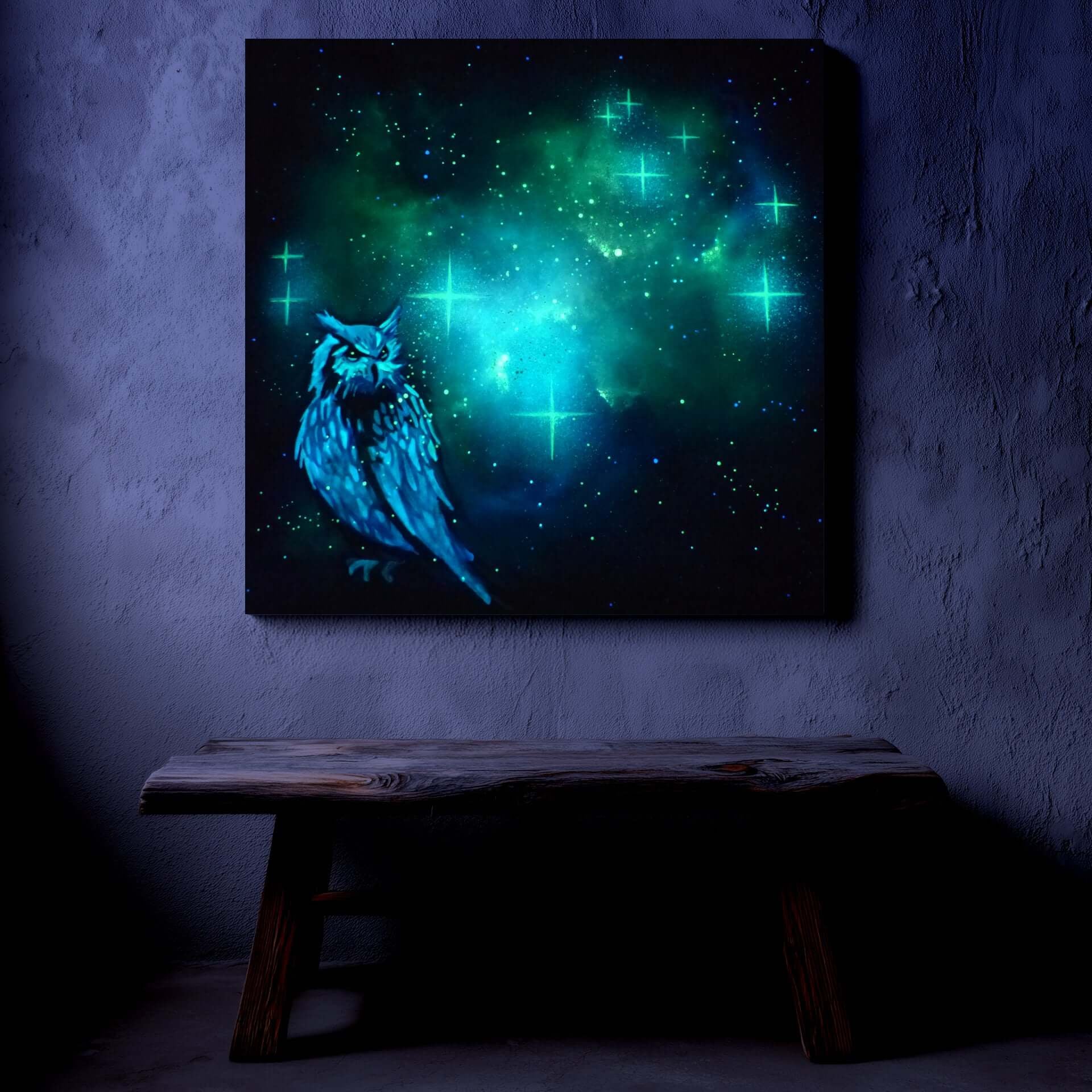 glow in the dark artwork of a owl with a glowing green and blue celestial background on a dark wall.