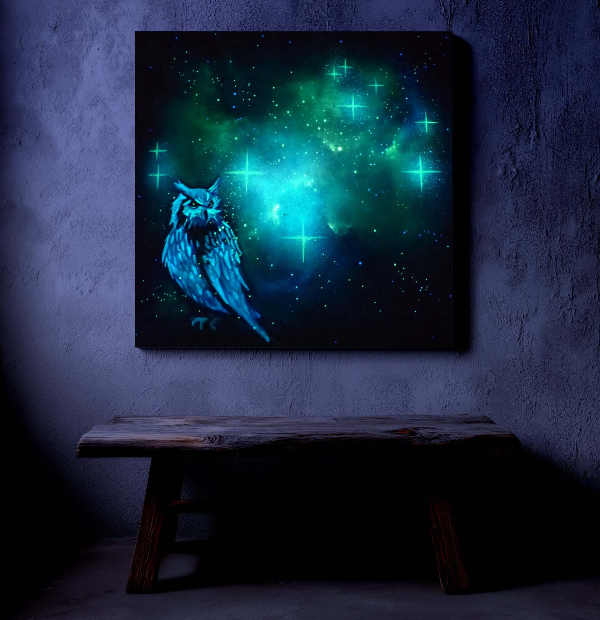 glow in the dark artwork of a owl with a glowing green and blue celestial background on a dark wall.