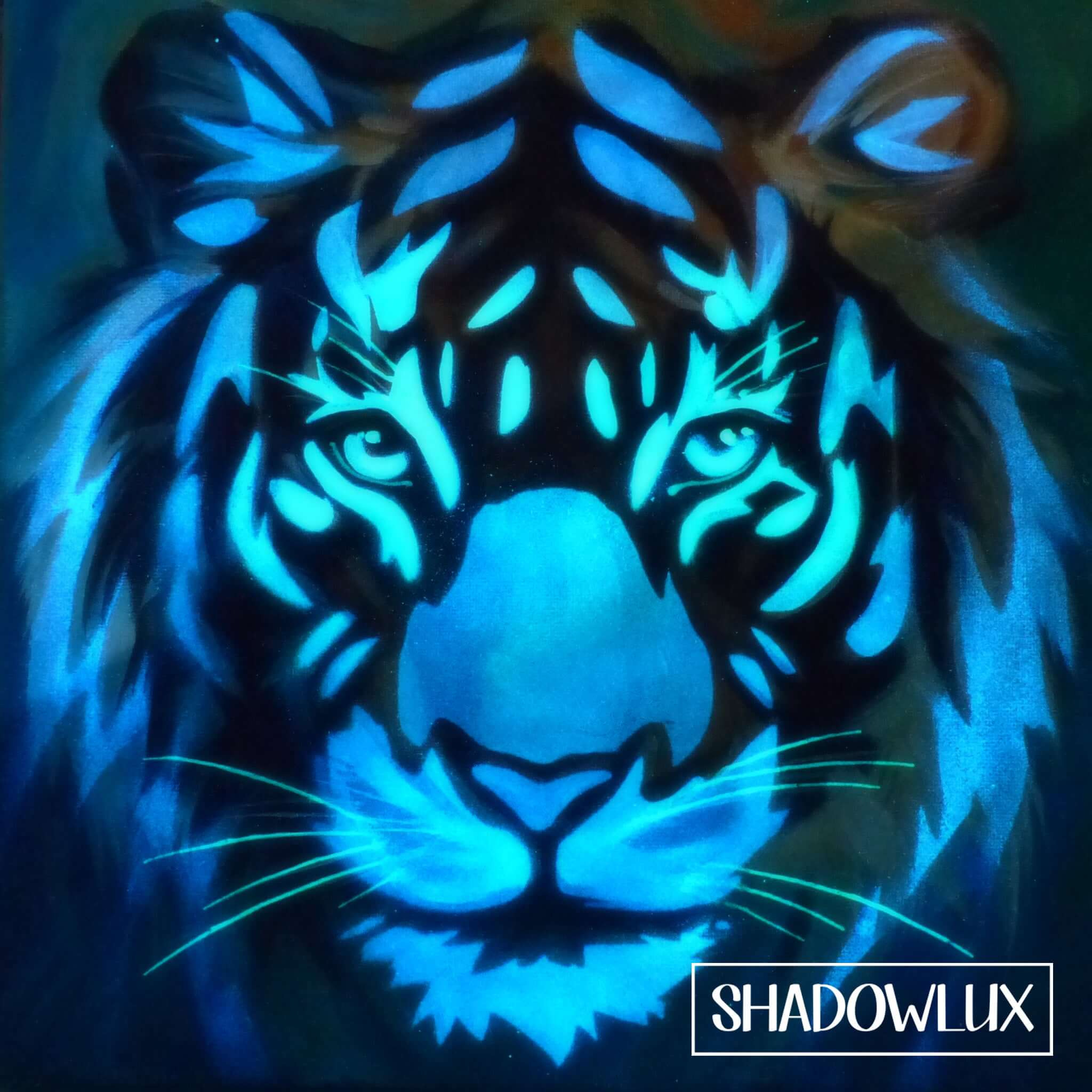 Luminous tiger face artwork glowing aqua and blue in the dark with vibrant markings
