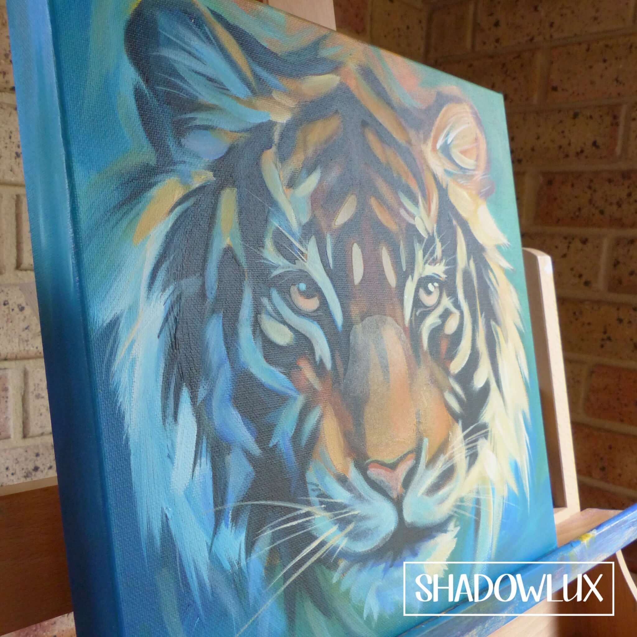 deep edge canvas artwork of a tiger with vibrant orange fur and black stripes, focusing on the face, painted in invisible glow paints