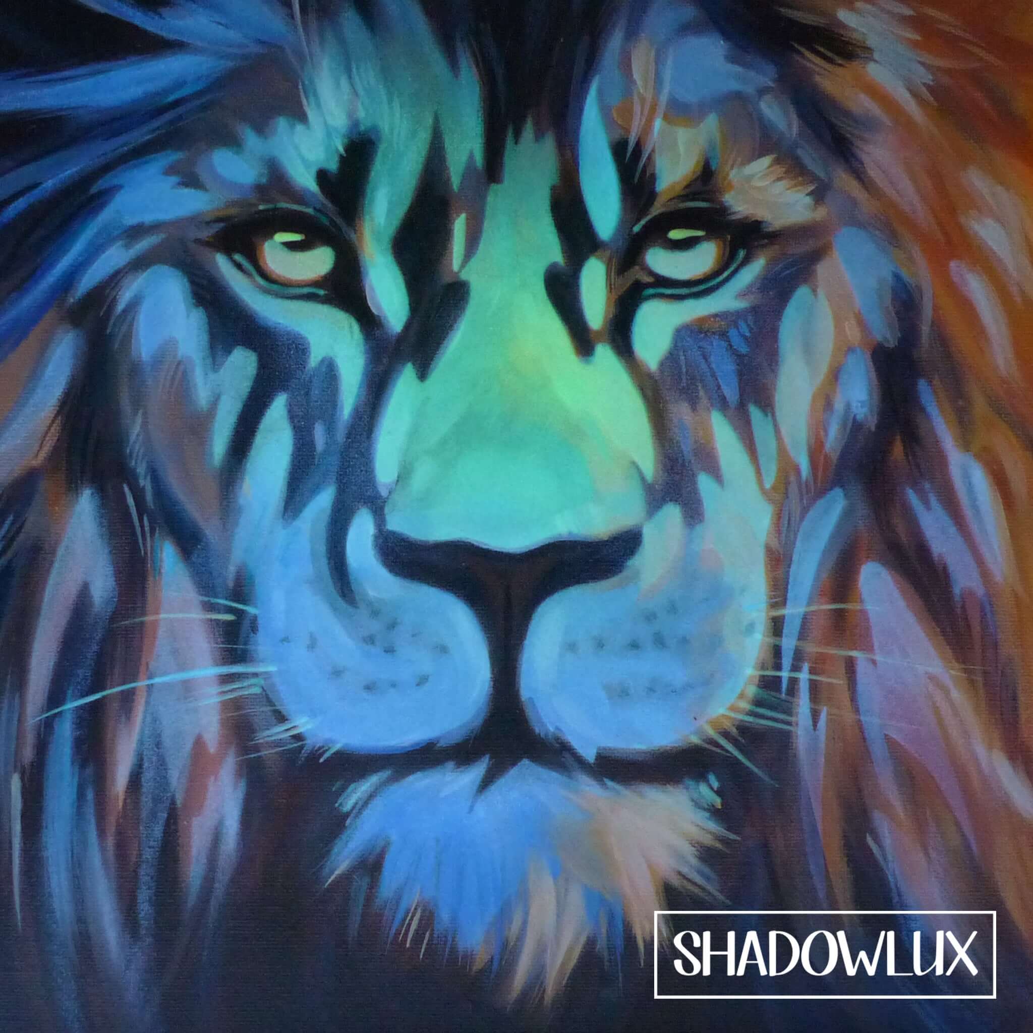 Glow-in-the-dark artwork of a lion’s face illuminated by soft glowing pigments in darkness