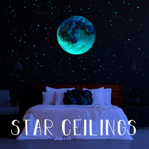 glow in the dark star ceiling with large moon decal in a dark bedroom.