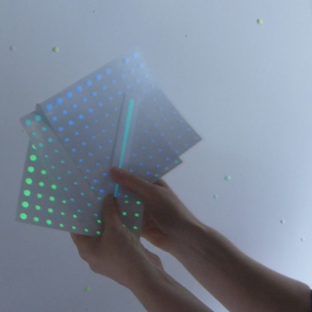 realistic glow in the dark stars being fixed to a wall