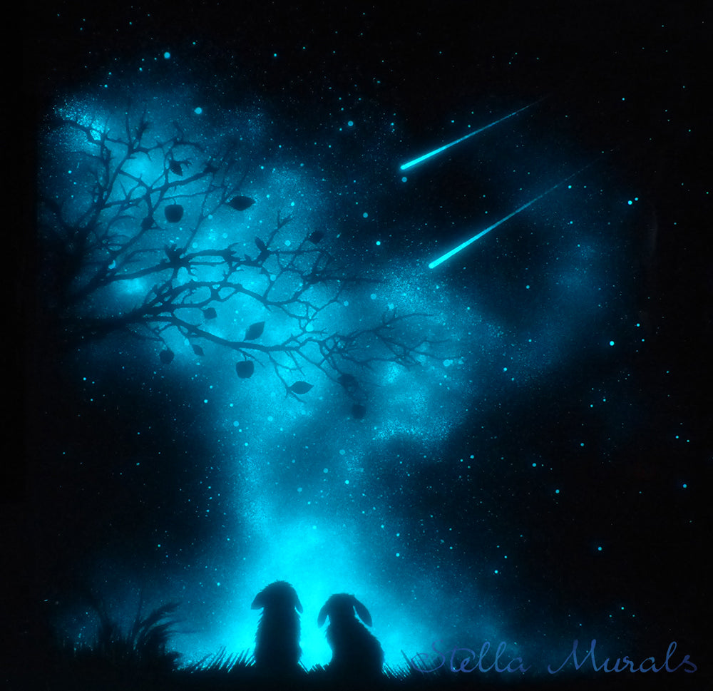 Shooting stars, a meteor shower watched by two little glow in the dark rabbits in the dark blue night.