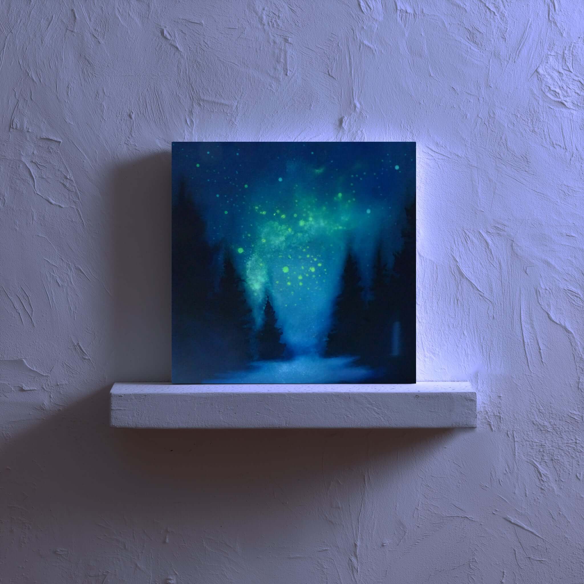 artwork of a forest under a starry night sky on a white ledge against a textured wall painted in uv paint