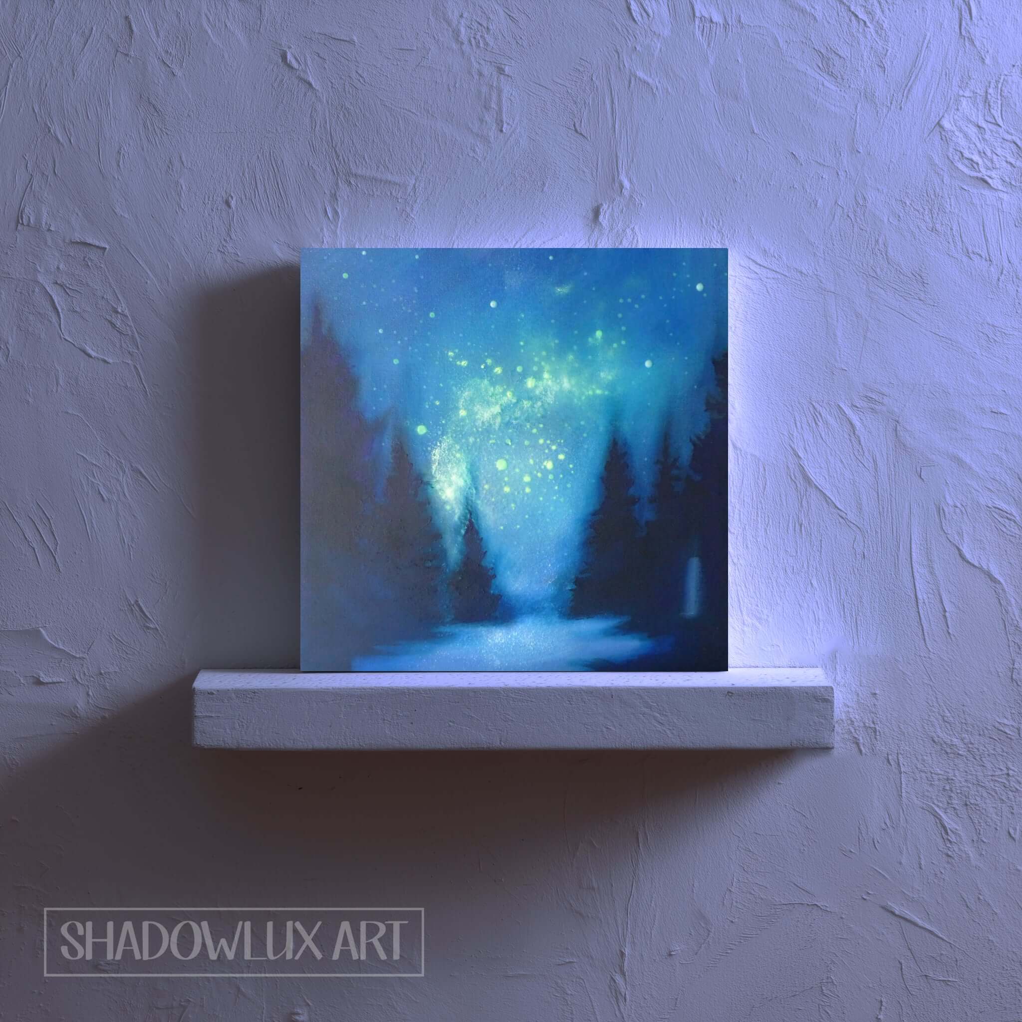 Artistic depiction of a forest with a glowing effect on a white shelf against a textured wall.
