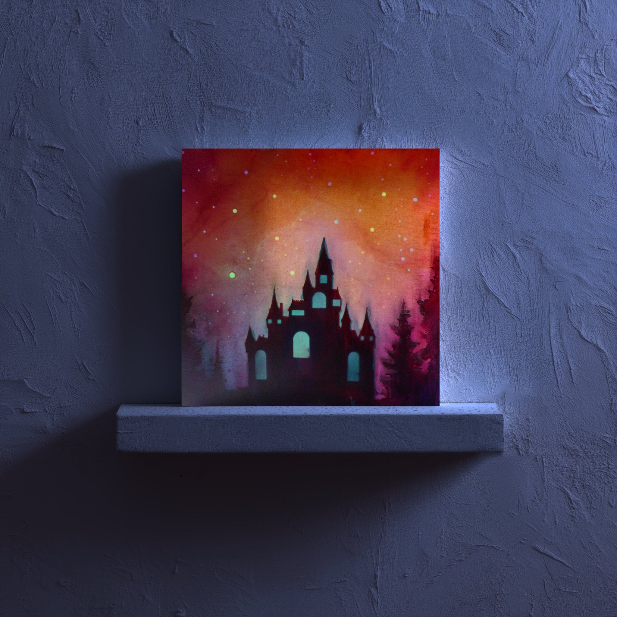 New glow artwork of a castle silhouette against a colorful sky on a dark wall.