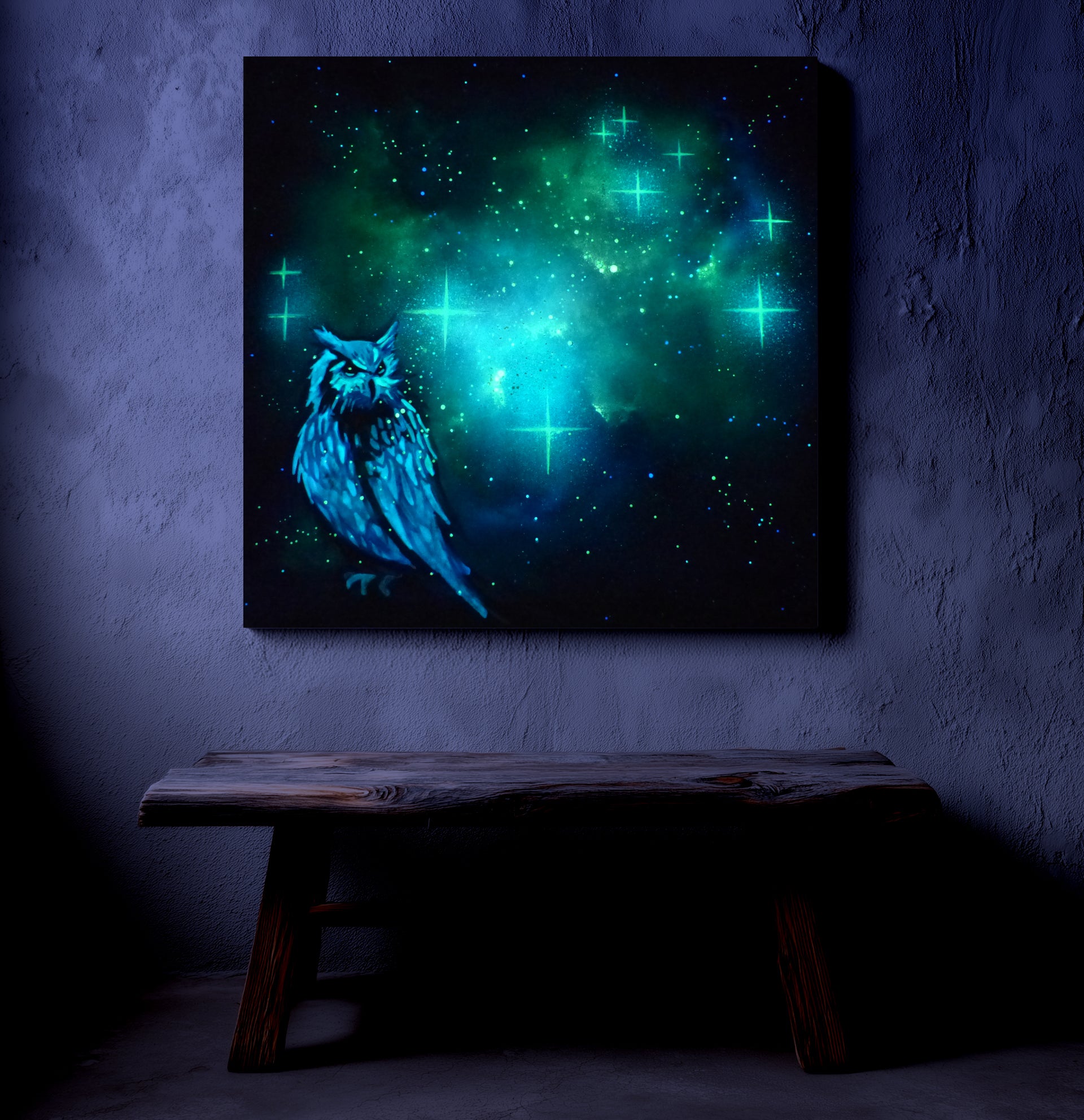 glow in the dark artwork of a owl with a glowing green and blue celestial background on a dark wall.