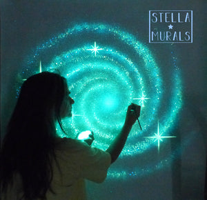 esther, artist from stella murals painting a glow in the dark spiral galaxy