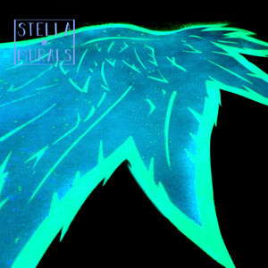 glowing close up of glow in the dark angel wings decal, a heavenly celestial and photoluminescent addition to bedroom home decor. 
