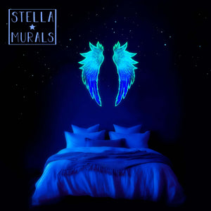Glow in the dark angel wings decal emitting an ethereal photoluminescent glow. A celestial heavenly blue glow in a fantasy bedroom.