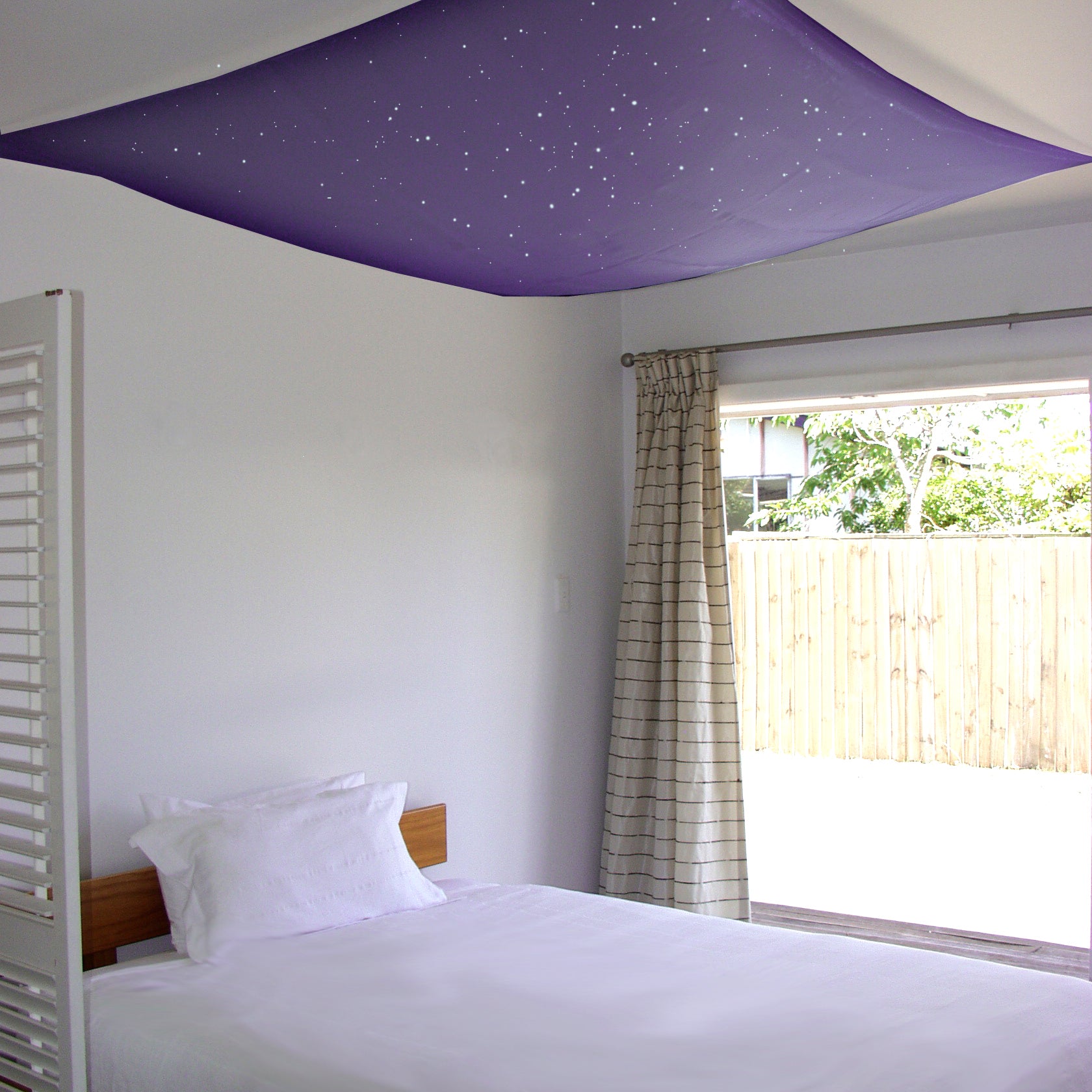 purple or lilac colour glow in the dark fabric, handpainted with stars